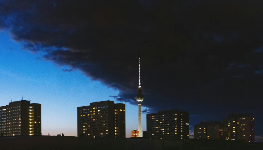 a tall tower towering over a city at night