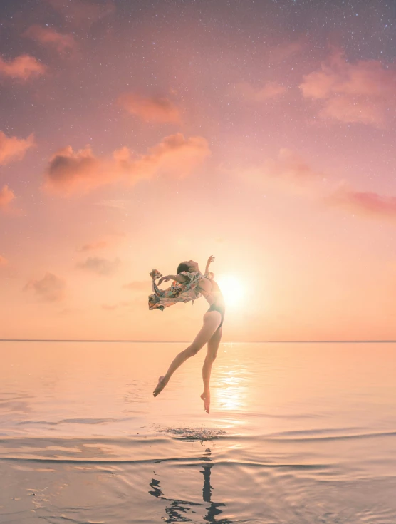 a woman is in the water with a sky background