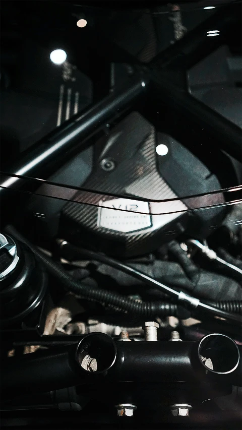 a closeup of the engine of a motorcycle at night