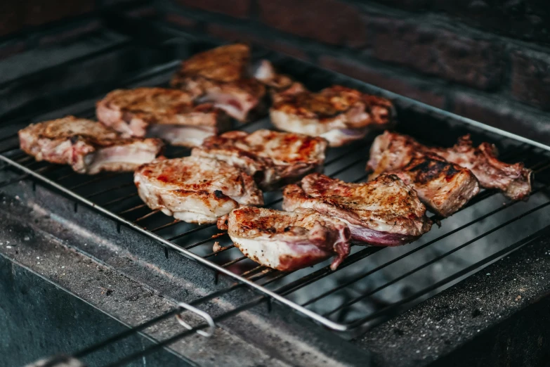 some pork is cooking on top of a grill