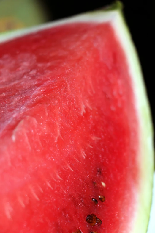 a watermelon slice on a white plate with other slices visible