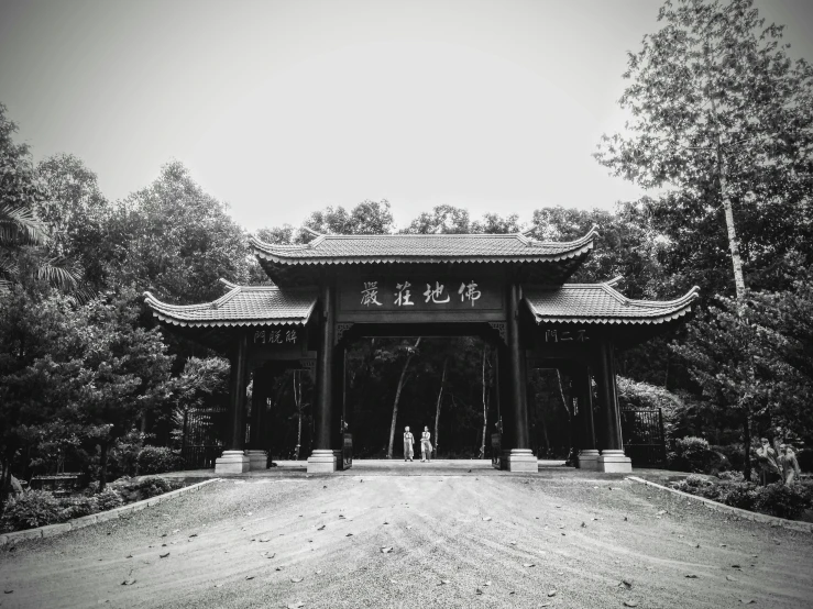 two people standing under a structure in a field