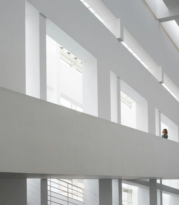 a person on the stairs of a building with a man standing at the window