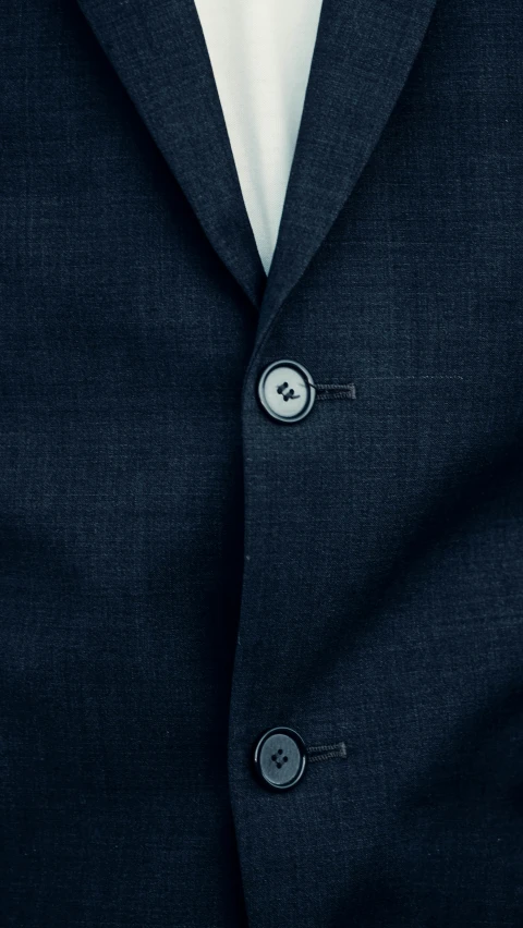 a close up view of a suit jacket with a shirt underneath