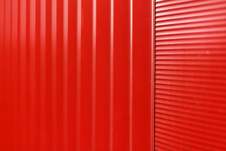 a red corrugated metal wall or door with no people inside