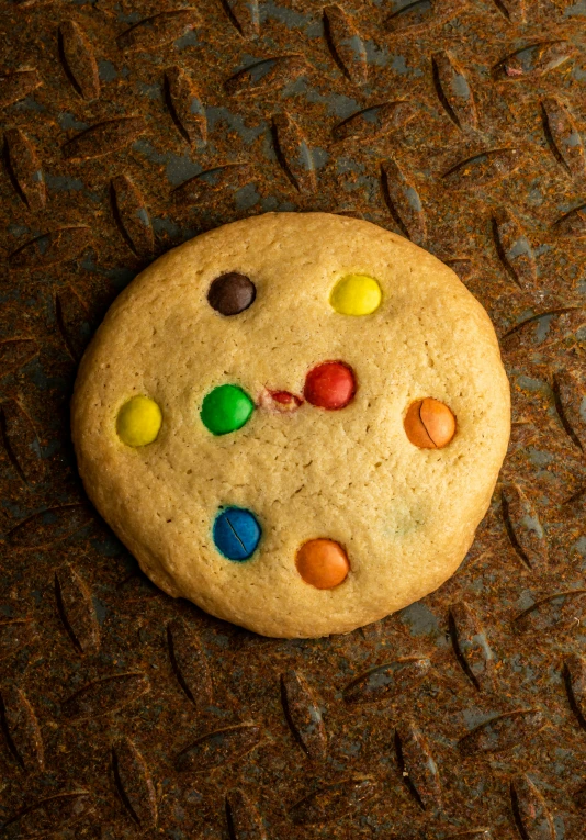 a cookie with m & ms all over it