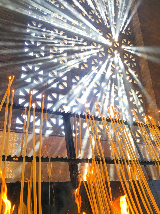 there are sticks connected to a structure and lit with bright lights