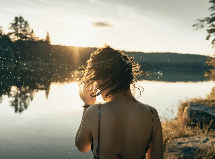 a woman who is walking next to a river