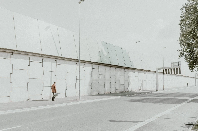 a person is walking on a street near a building