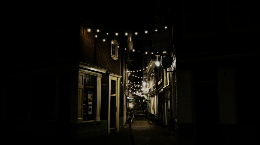 a street with lots of lights strung from it