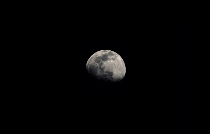 the moon from the far space looks very dark