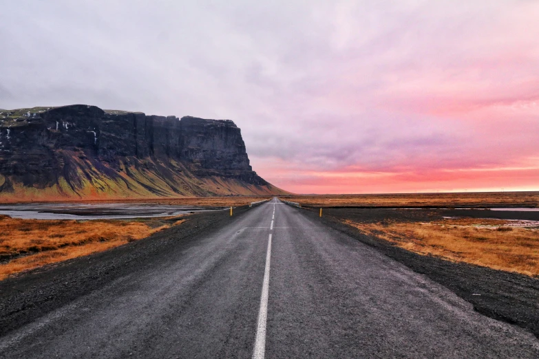 an empty road leads out to the mountain