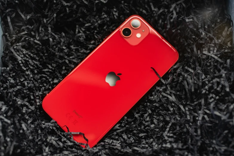 a broken red iphone case laying on a piece of paper