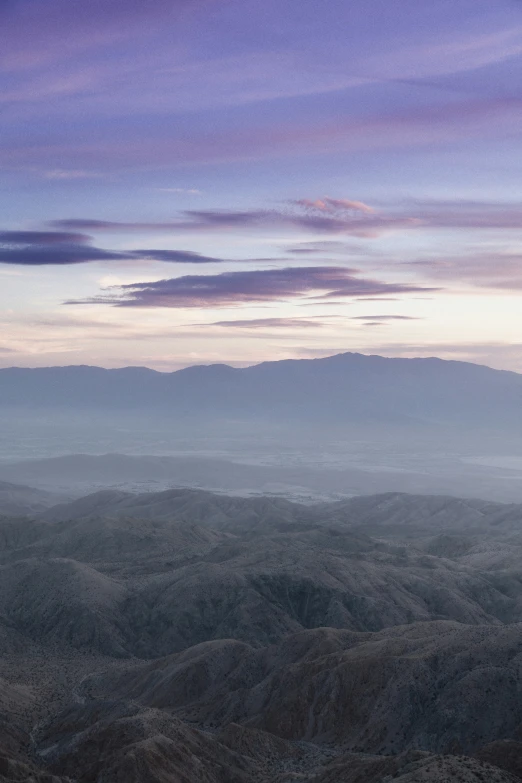 a panoramic view of an arid desert with clouds