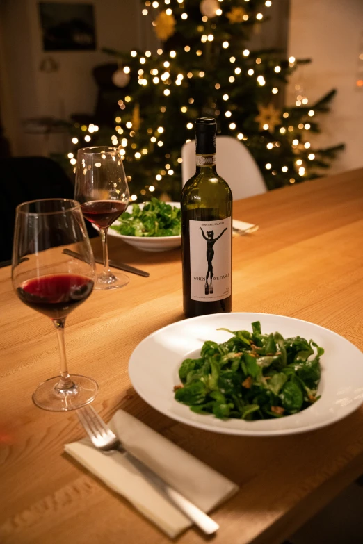 a bottle of wine and glass of wine on a table