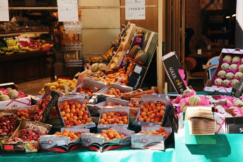 a produce stand showing oranges and fruits in baskets