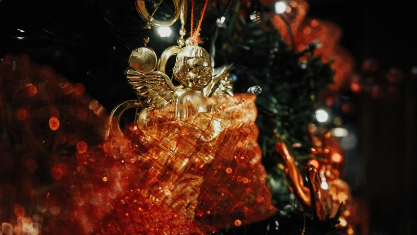 a close up of the angel decoration on a tree