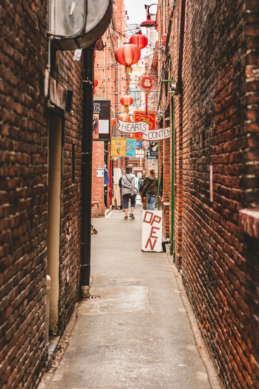 an alley way between two buildings with a man riding a horse on one of the lanes