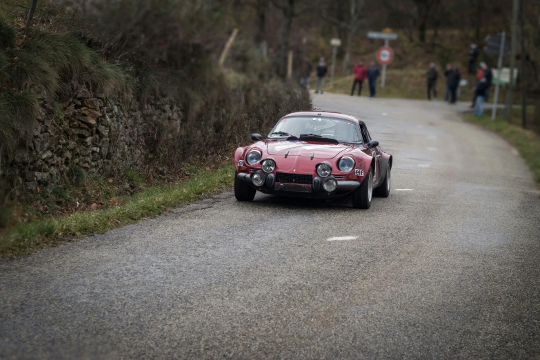 the car is driving on the road, in the rain