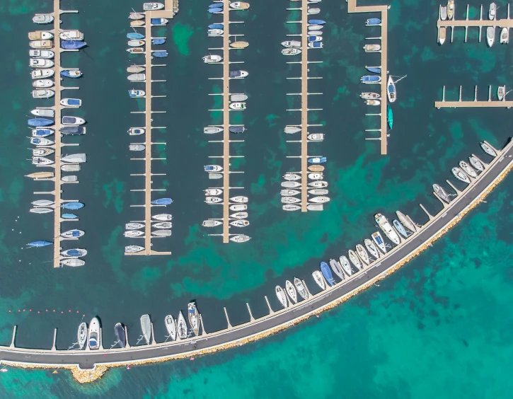 the aerial view of boats and yachts parked at the marina