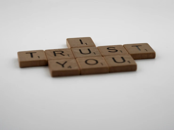 a crossword spelling on a table that says trust you