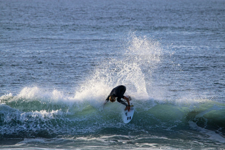 a surfer in the middle of a wave on his surfboard