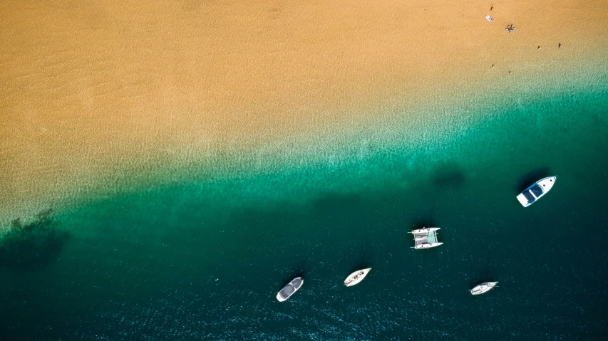 a blue ocean filled with lots of boats