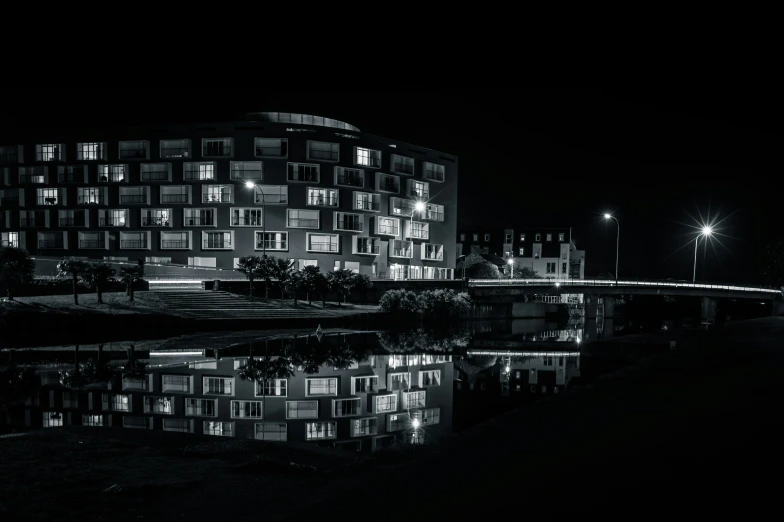 an apartment building at night with its lights on