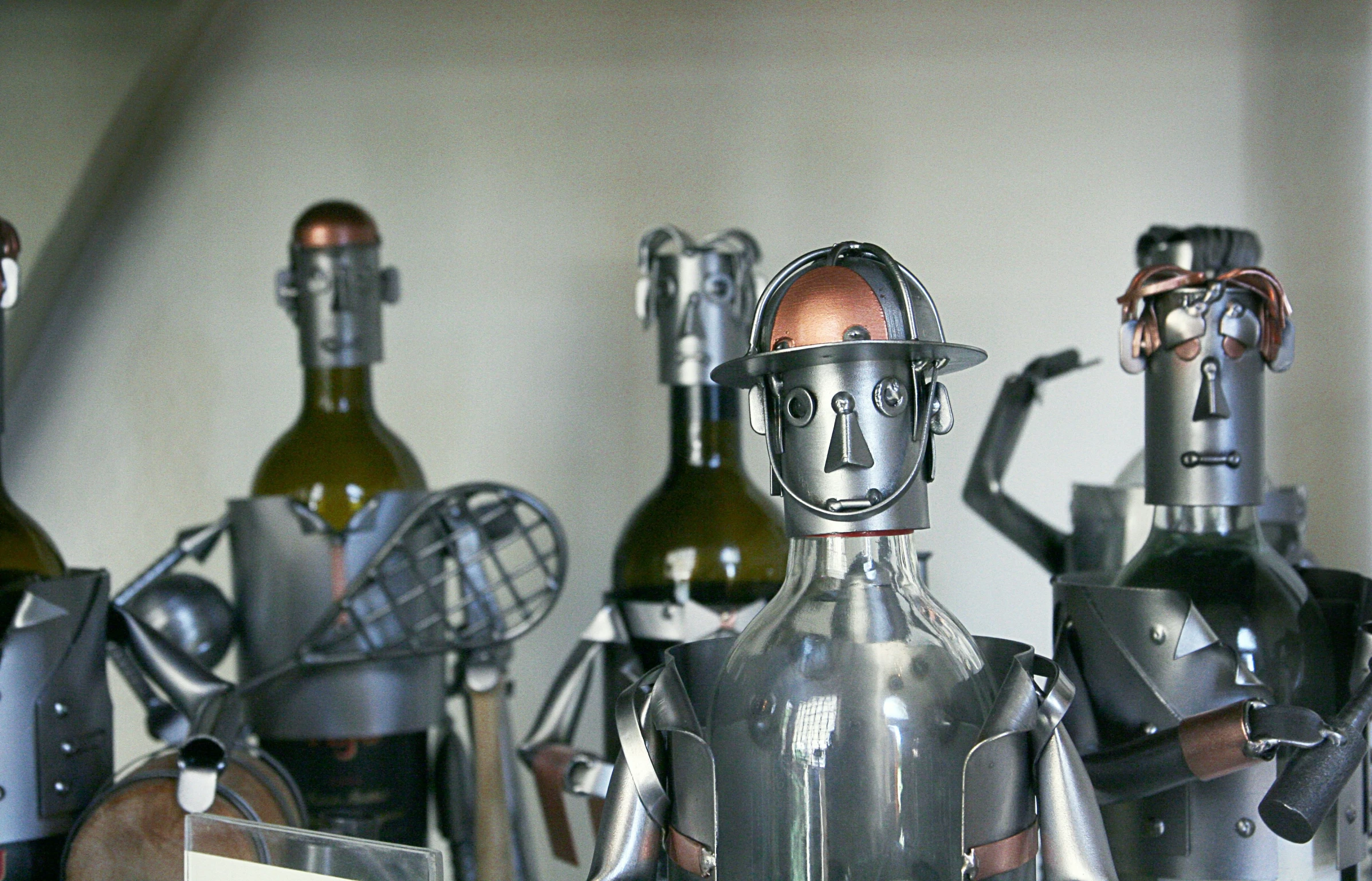 some bottles and metal toys are standing together