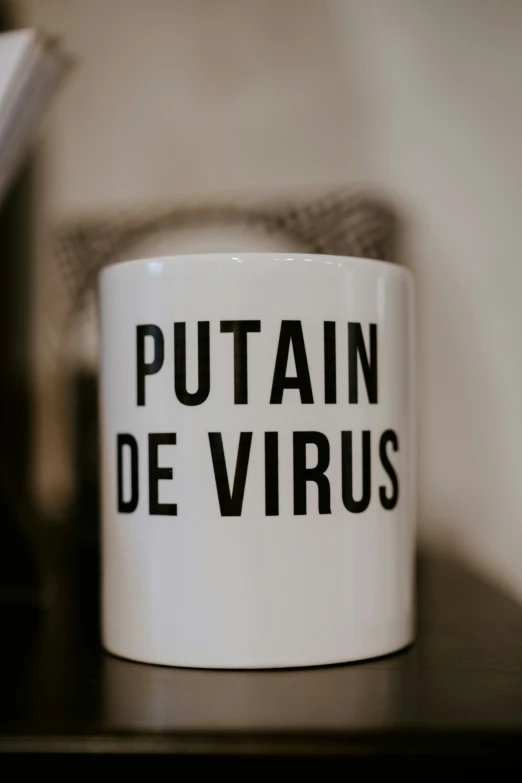 a white coffee mug with the words putain de virus