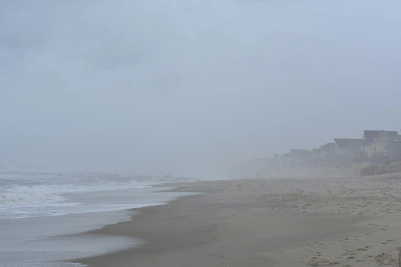 beach with many sand and buildings in the distance