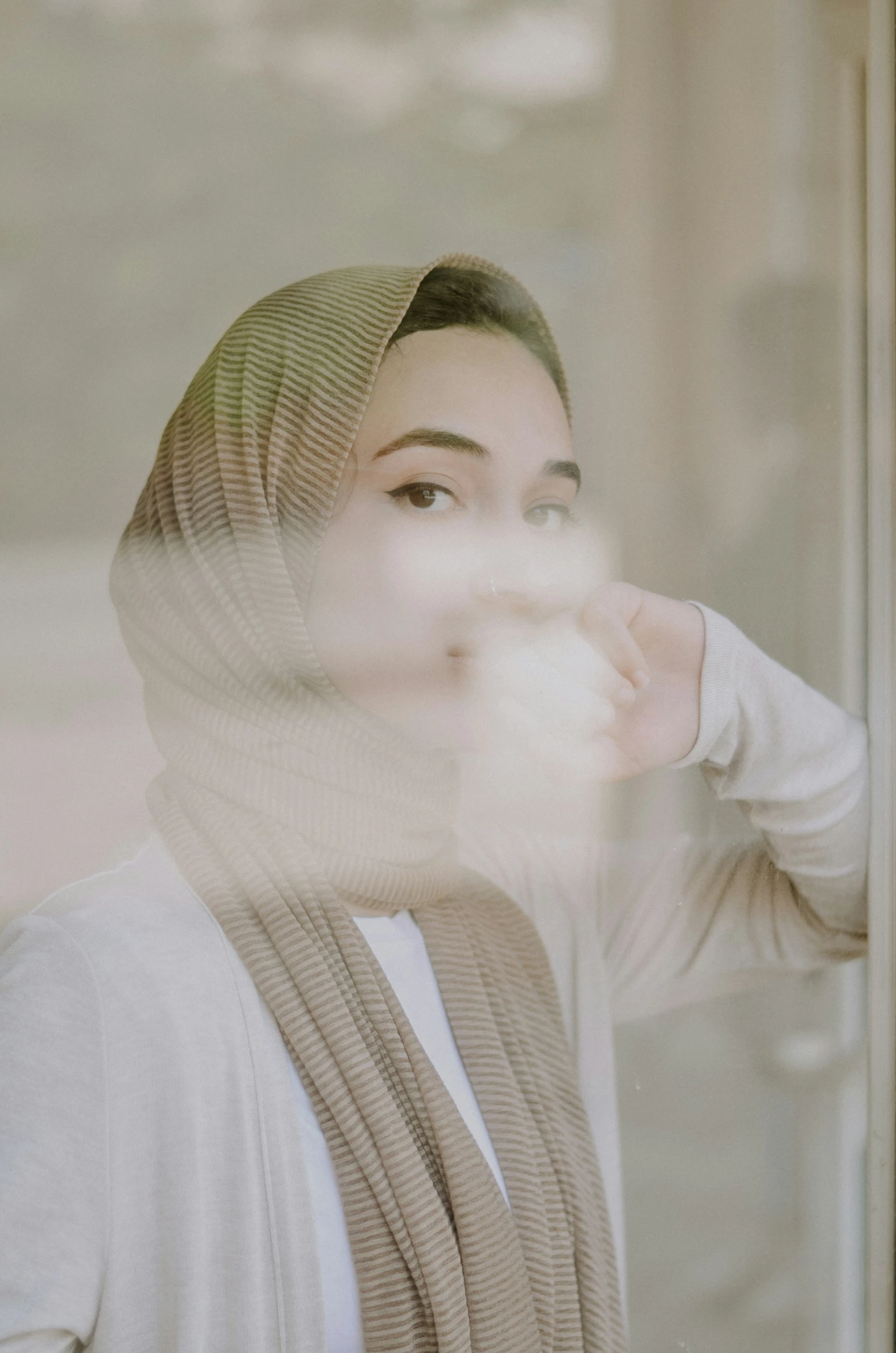 a woman with a white scarf and a light grey jacket