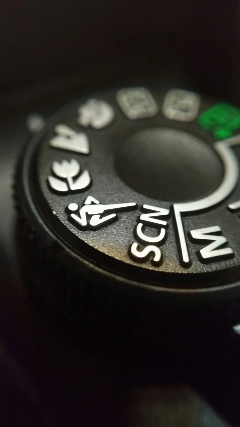 a closeup of a remote control with the word stop and 2 green arrows on it