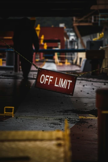 a person walking past an off limit sign