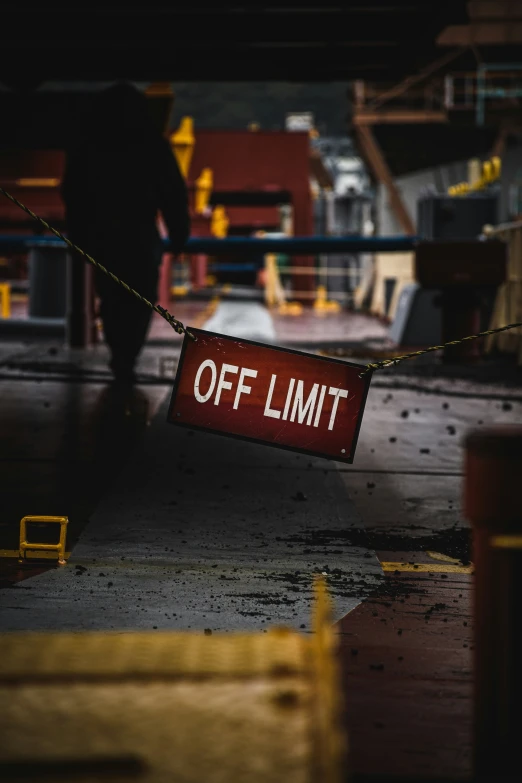 a person walking past an off limit sign