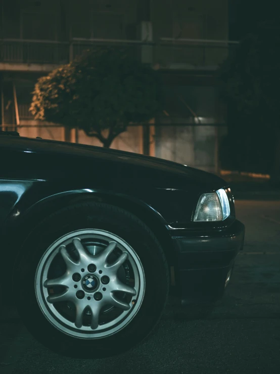 a black car parked on the street at night