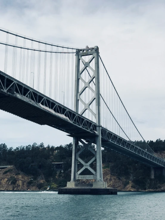 a large bridge over a river with a train track crossing