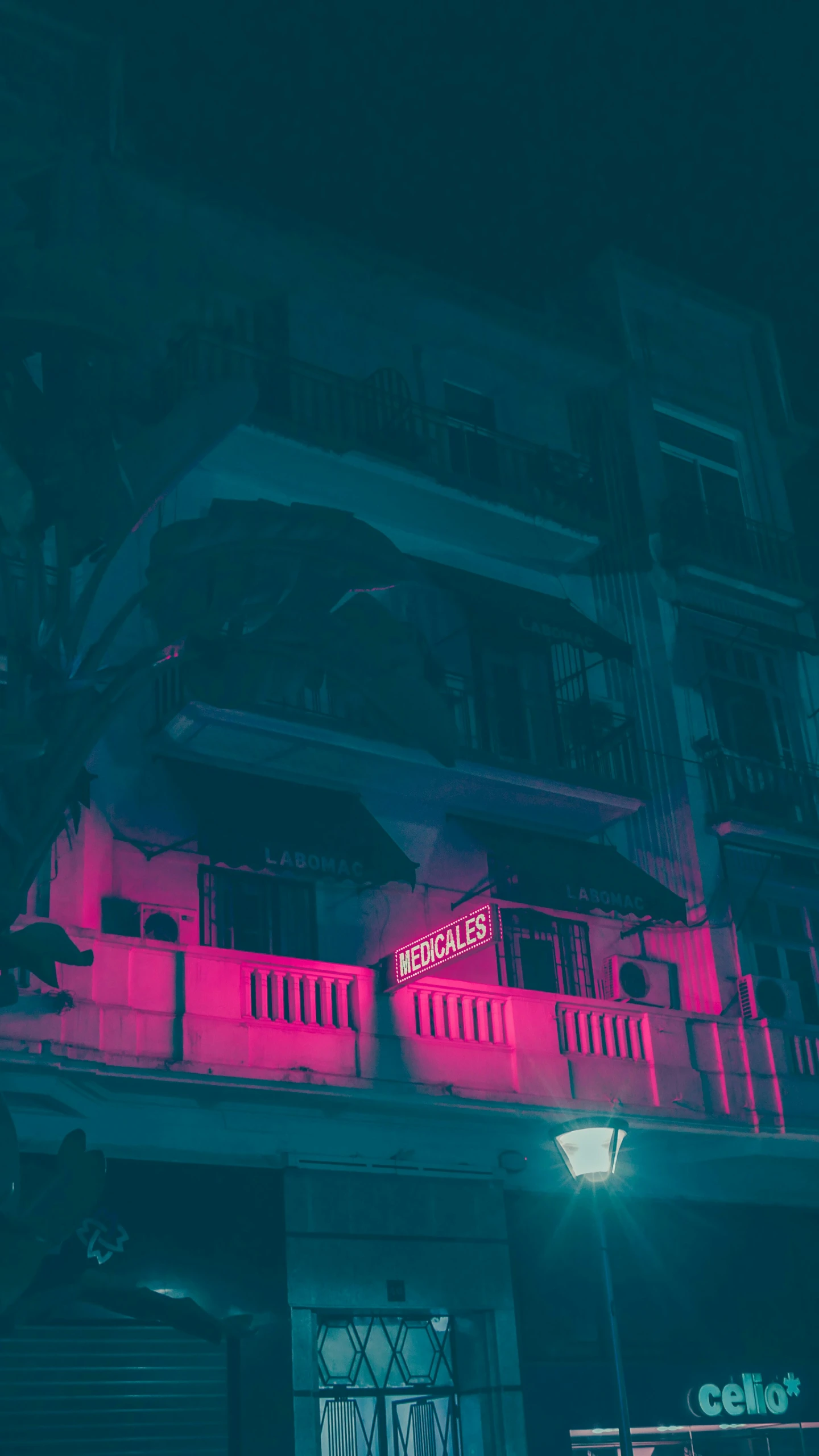 a building with bright neon pink lights shining