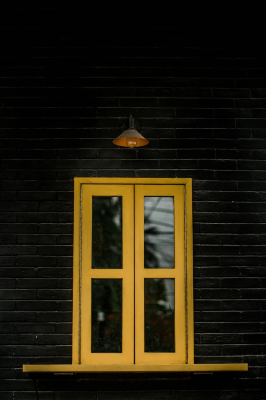 a yellow window on the side of a building