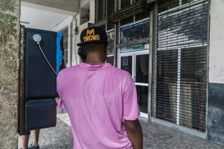 a man standing outside of a bank and looking into the back