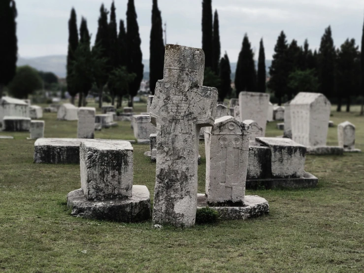 a number of old tombstones in a field