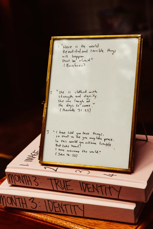 the three books have handwriting on them and an image of a picture