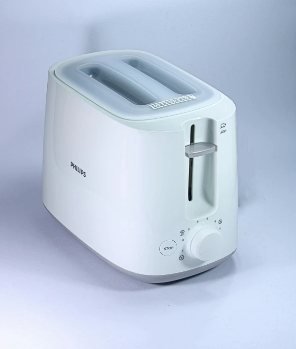 a toaster sitting on a table in the white room