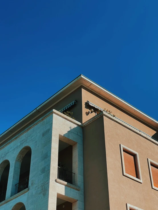 a tan building with a light brown clock on the front