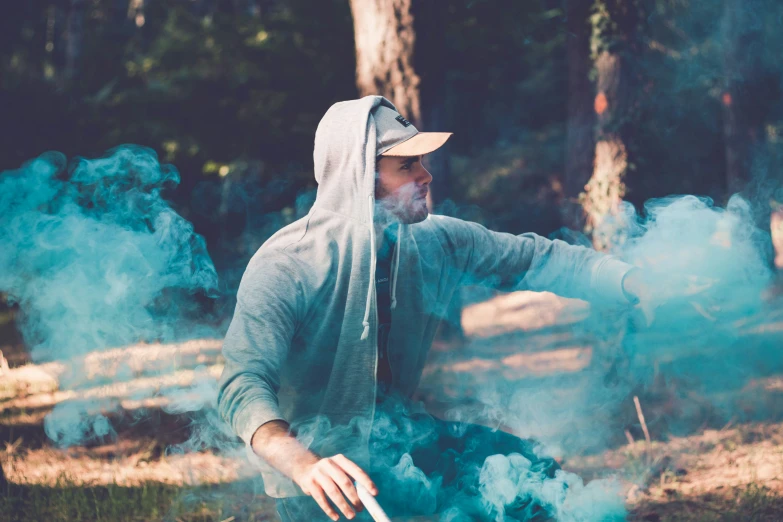 man in grey hoodie cooking on  coal grill