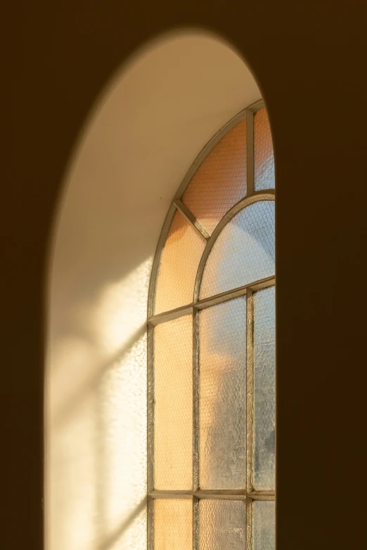 view of an arched window with stain glass in the center