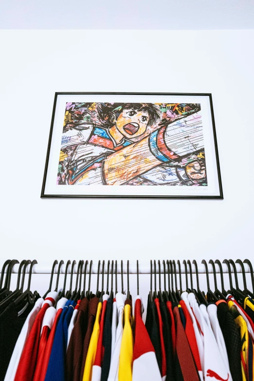 some shirts and some hangers with pictures above them