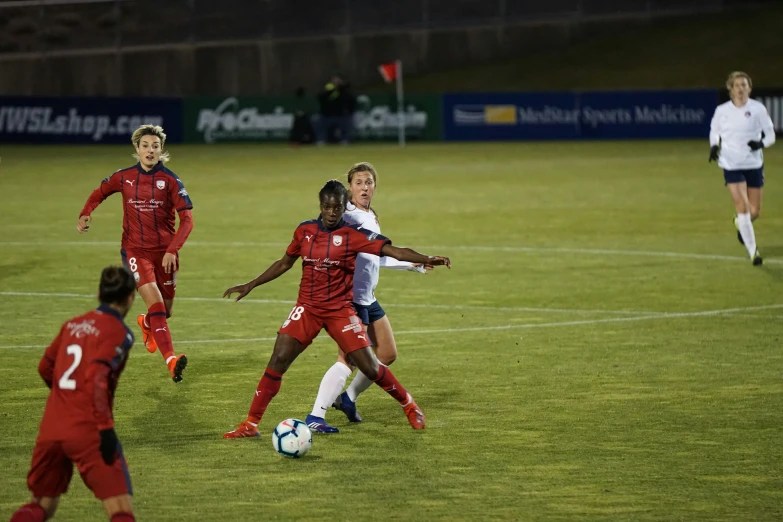 two teams of s playing soccer on a soccer field