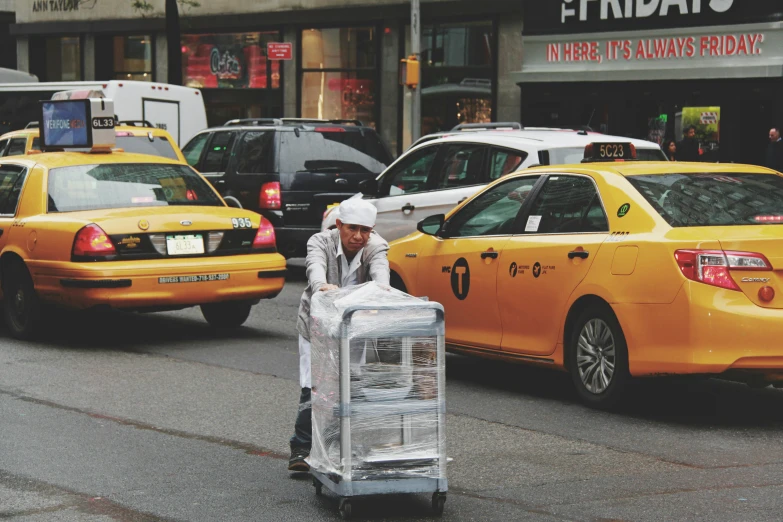 a man hing a luggage bag across the street