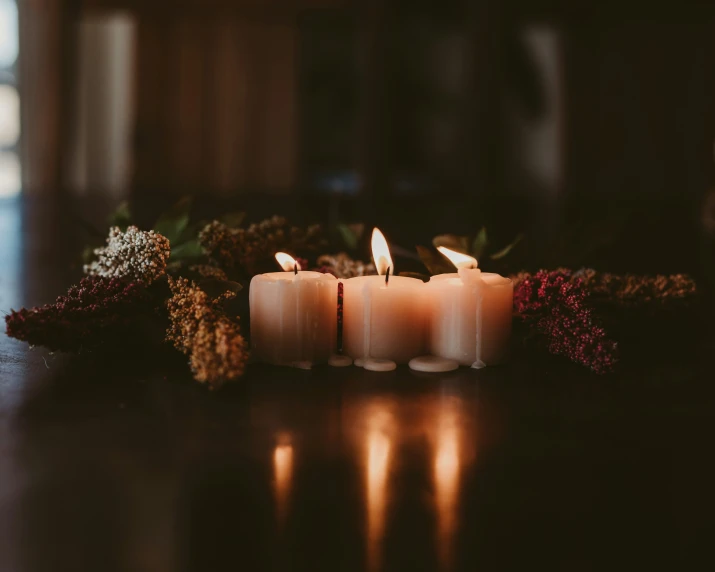 a table that has candles and a bunch of flowers